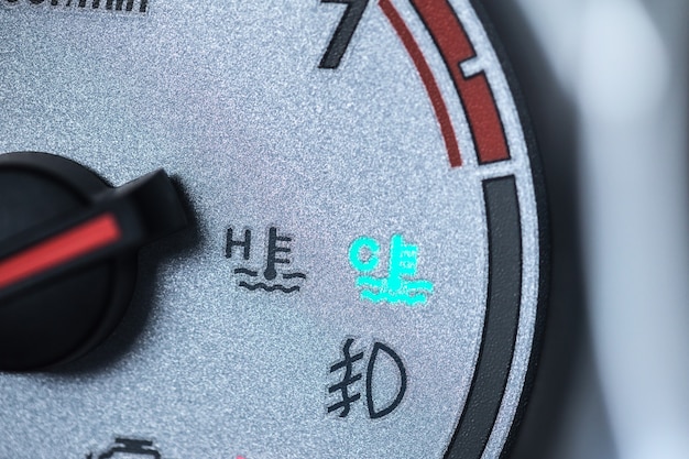 A close-up of a fuel gauge in a car, showing it near empty. The background is blurred, focusing attention on the high consumption of fuel. A reminder of the environmental impact of transportation.