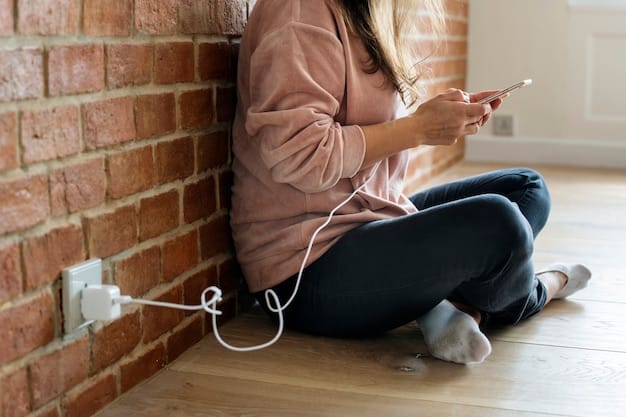 A person unplugging a phone charger from a wall socket, with other electronic devices nearby, all with a focus on reducing energy consumption. The setting is a cozy living room.