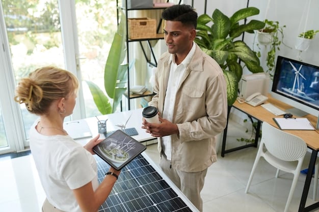 An energy consultant is discussing energy storage solutions with a business owner in a modern office setting. The consultant is pointing to a tablet displaying energy consumption data and demonstrating the benefits of energy storage. The background shows a collaborative work environment with other employees.