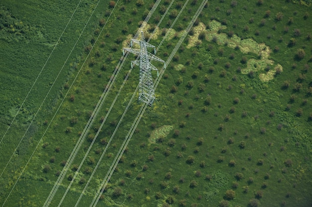 An aerial view of a modern, smart grid infrastructure, showcasing the integration of renewable energy sources (solar panels and wind turbines) with advanced energy storage systems and transmission lines. The image conveys a sense of connectivity, efficiency, and sustainability in the energy sector.