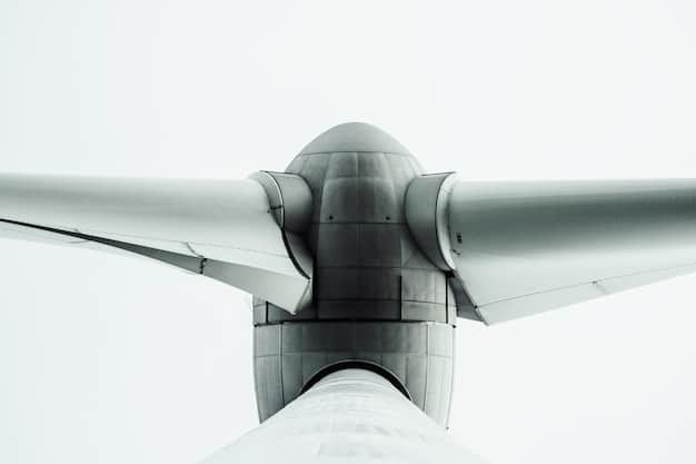A detailed close-up of a modern wind turbine, showcasing its sleek design and powerful blades against a partly cloudy sky. The image focuses on the technological advancements in renewable energy.