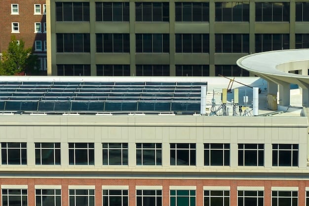 A solar panel installation on a large commercial rooftop, with a cityscape visible in the background, illustrating urban renewable energy integration.