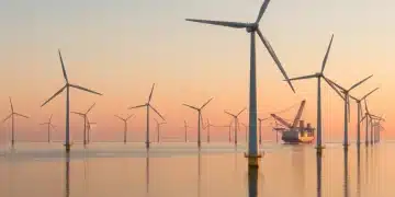 Offshore wind farm at sunrise, symbolizing renewable energy progress in the US.